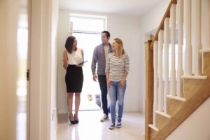 realtor showing young couple around property