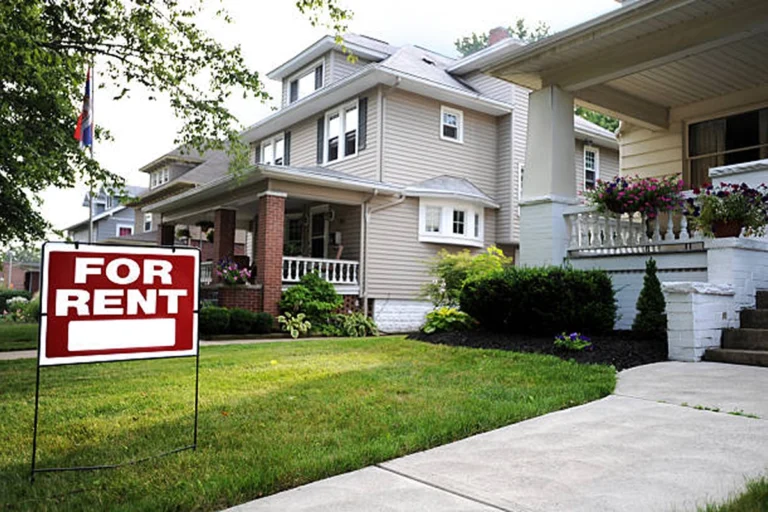 House with rental sign in front