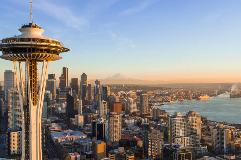 Aerial view of the Seattle skyline with the Space Needle and Mount Rainier, home to the Seattle property management companies compared in this guide