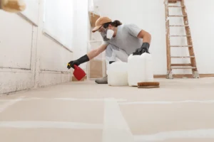 Mold remediation professional treating visible mold on a rental property wall in Washington