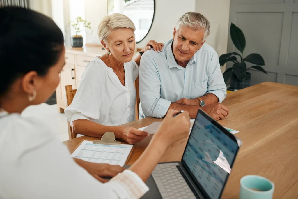 Couple reviewing paperwork with an advisor at a table